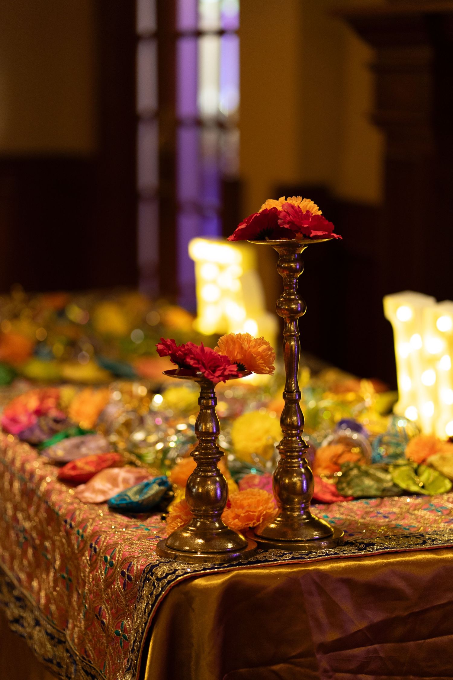 Candles on top of reception table at wedding venue at an Indian wedding