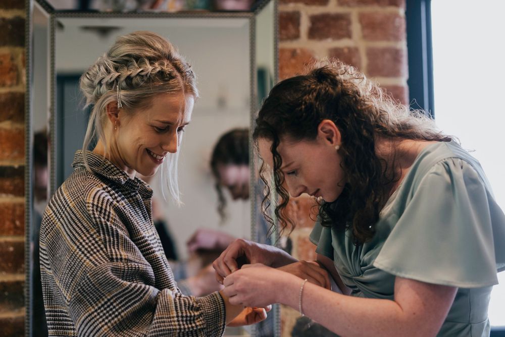Series of candid moments showing people having a joyful gathering in a rustic brick interior space.