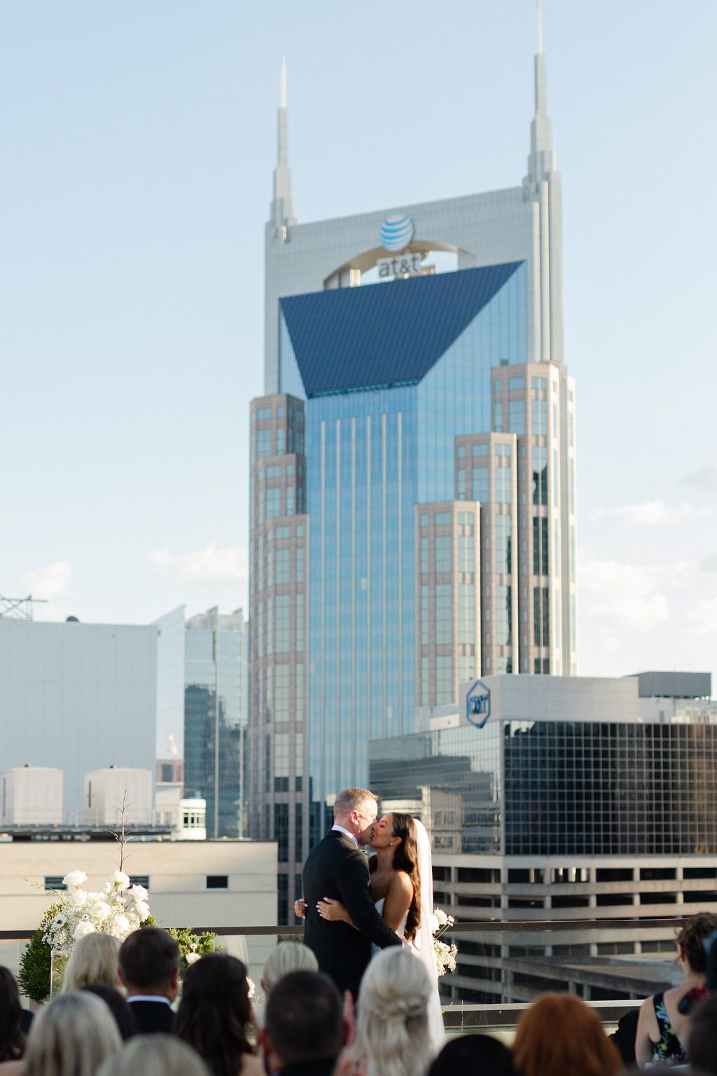 An outdoor rooftop wedding ceremony with the iconic AT&T Batman Building in downtown Nashville as the backdrop. Top 10 Nashville Wedding Ven