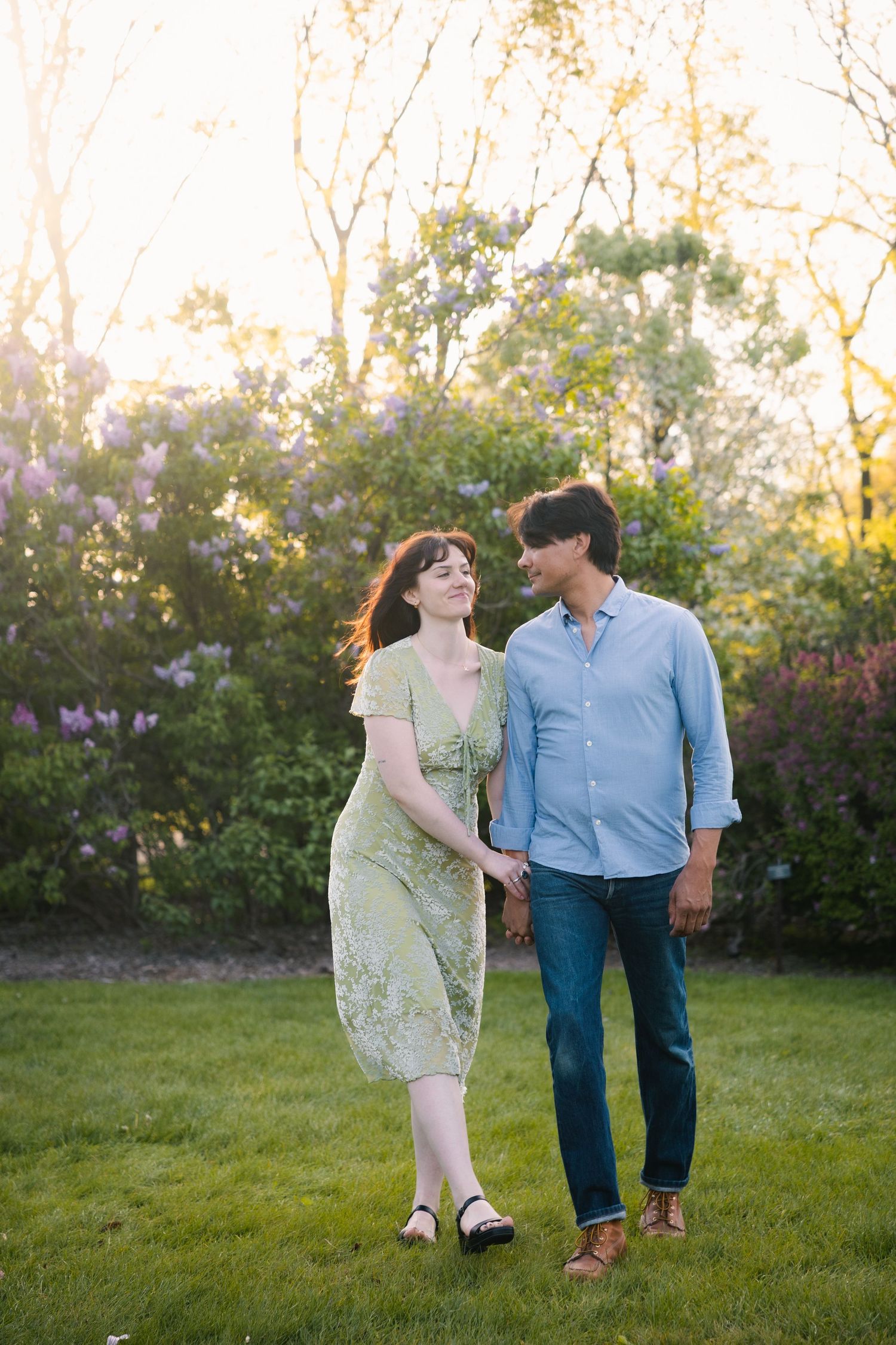 madison wi enagement couple photoshoot professional photographer spring uw arboretum cherry blossom trees lilacs walking candid middleton