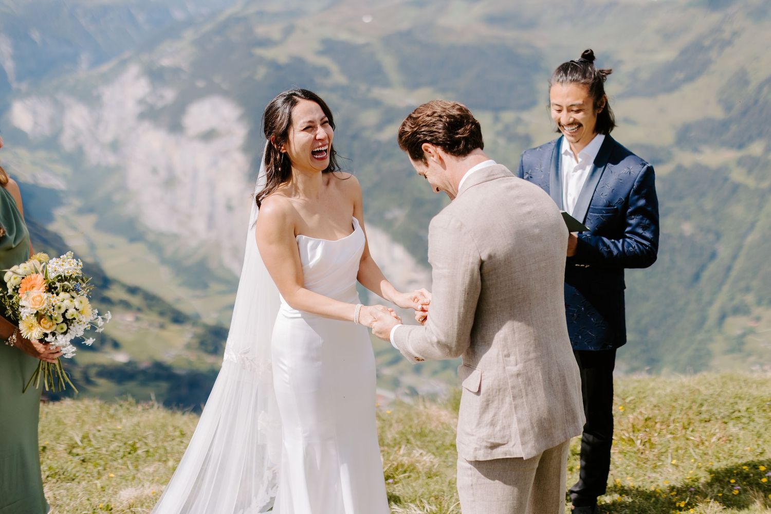 Mountain wedding ceremony with stunning valley views as couple exchanges vows surrounded by loved ones.