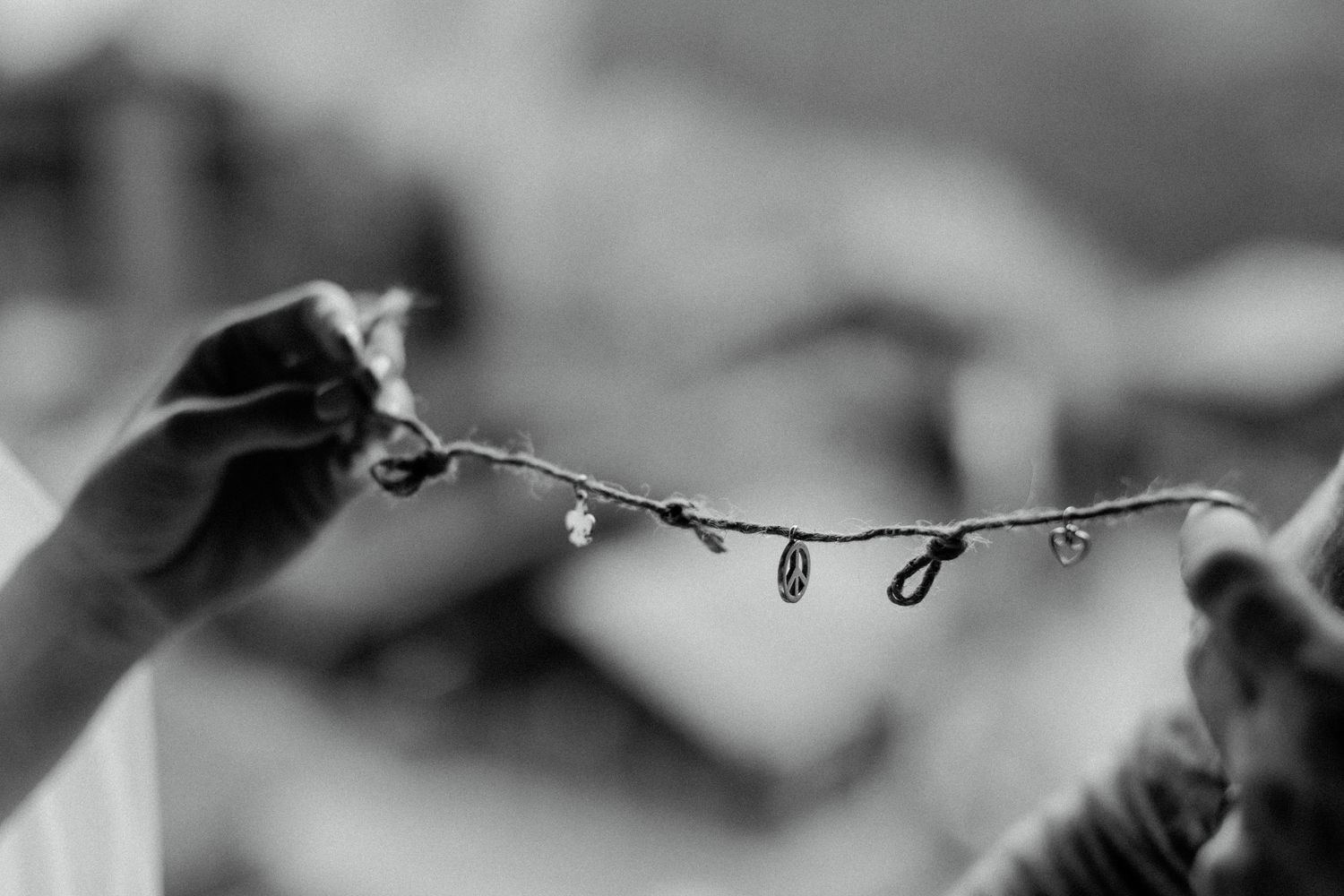 Black and white artistic detail shot of water droplets on a branch.