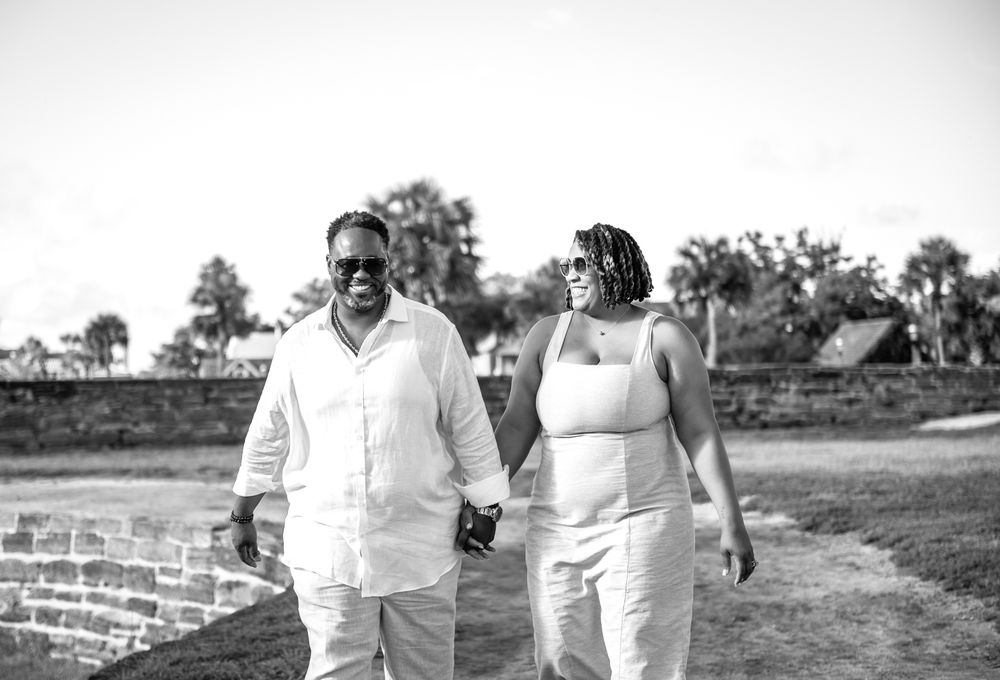 Grace and Jay pose against the ancient coquina walls of Castillo de San Marcos, photographed by Treasure Coast wedding photographers.