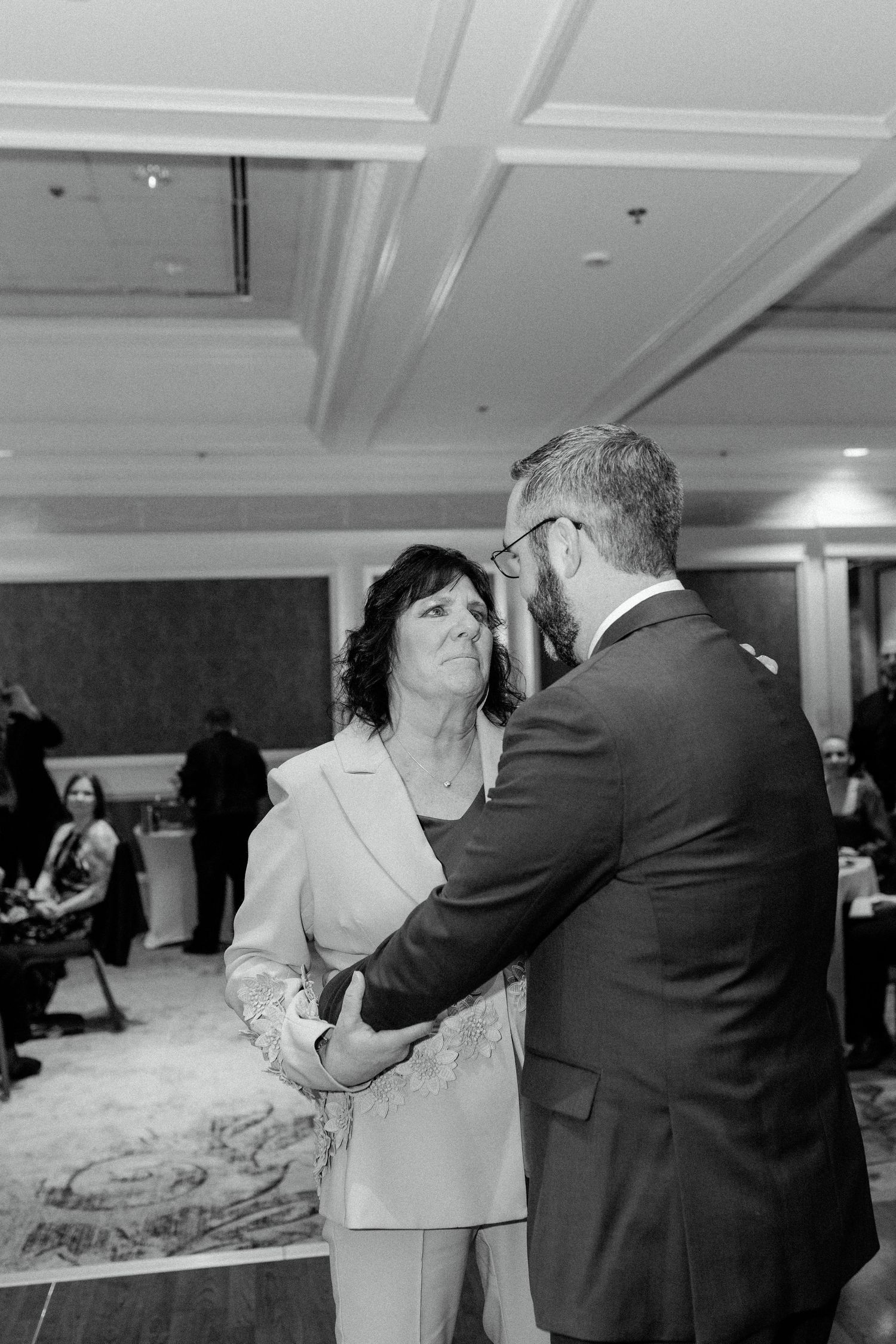 An intimate dance moment captured during a wedding reception in a grand ballroom.