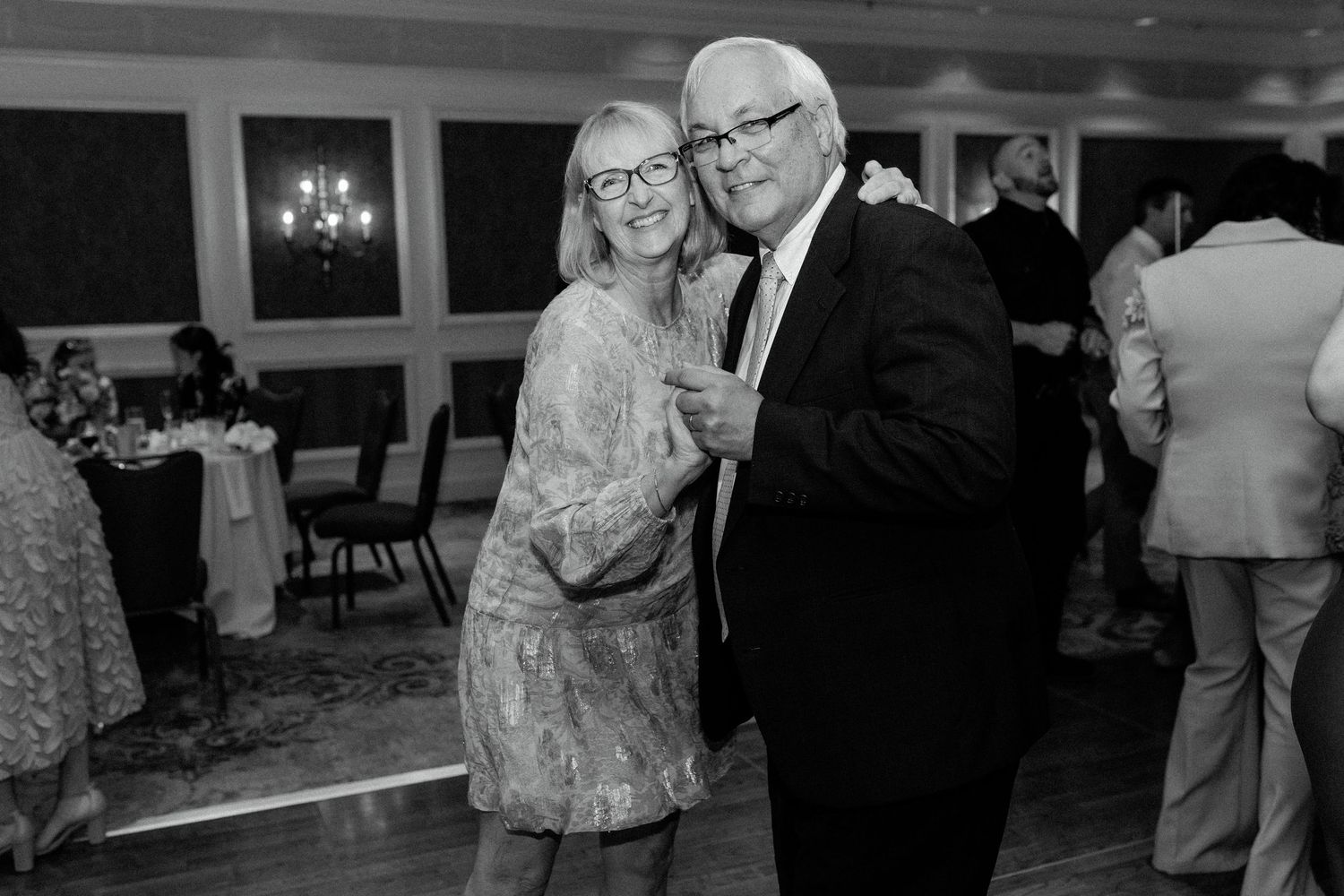 A row of black and white photos showing couples dancing and socializing at what appears to be a formal event.