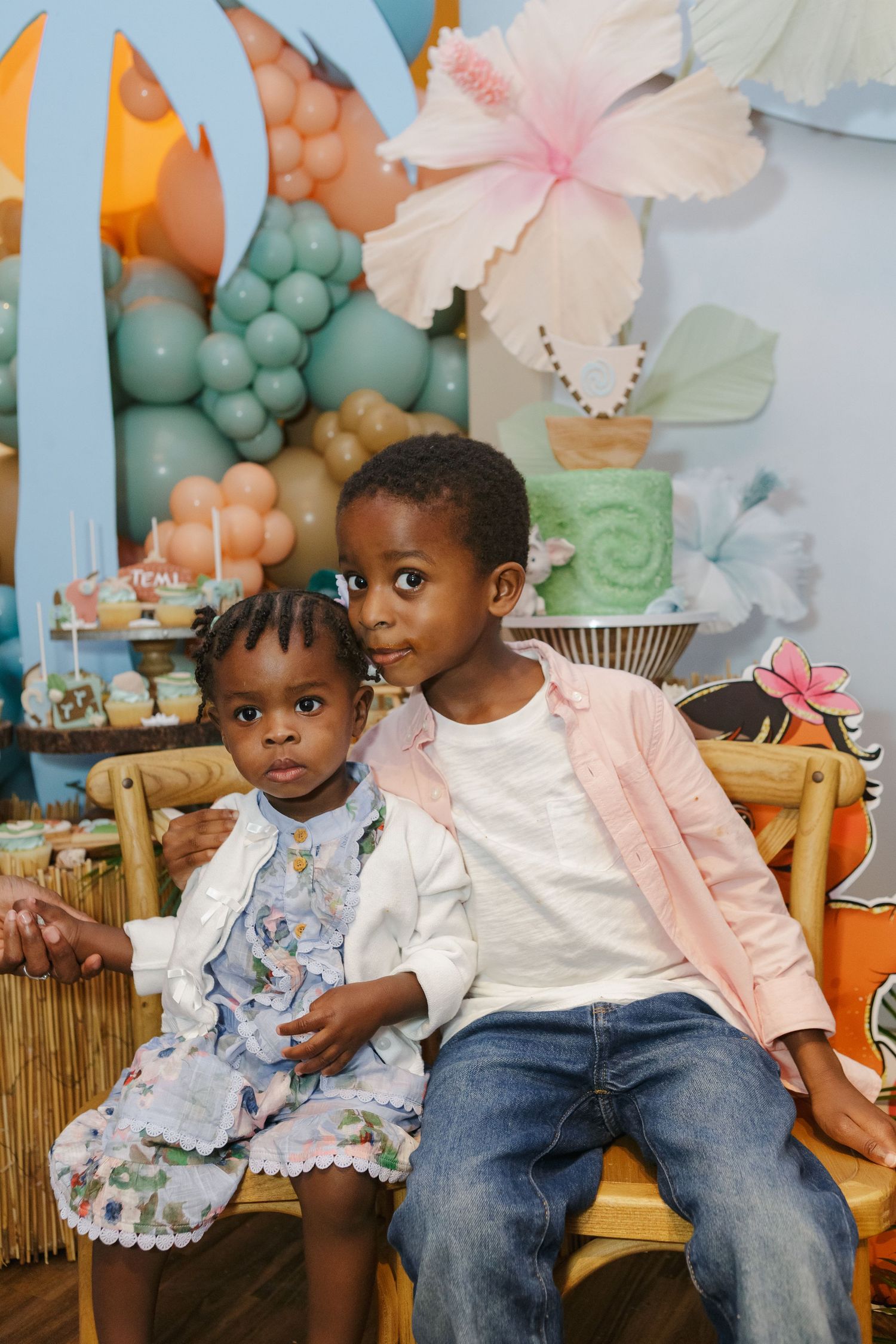Joyful moment—birthday boy and birthday girl smiling together at their Moana-themed party in NYC