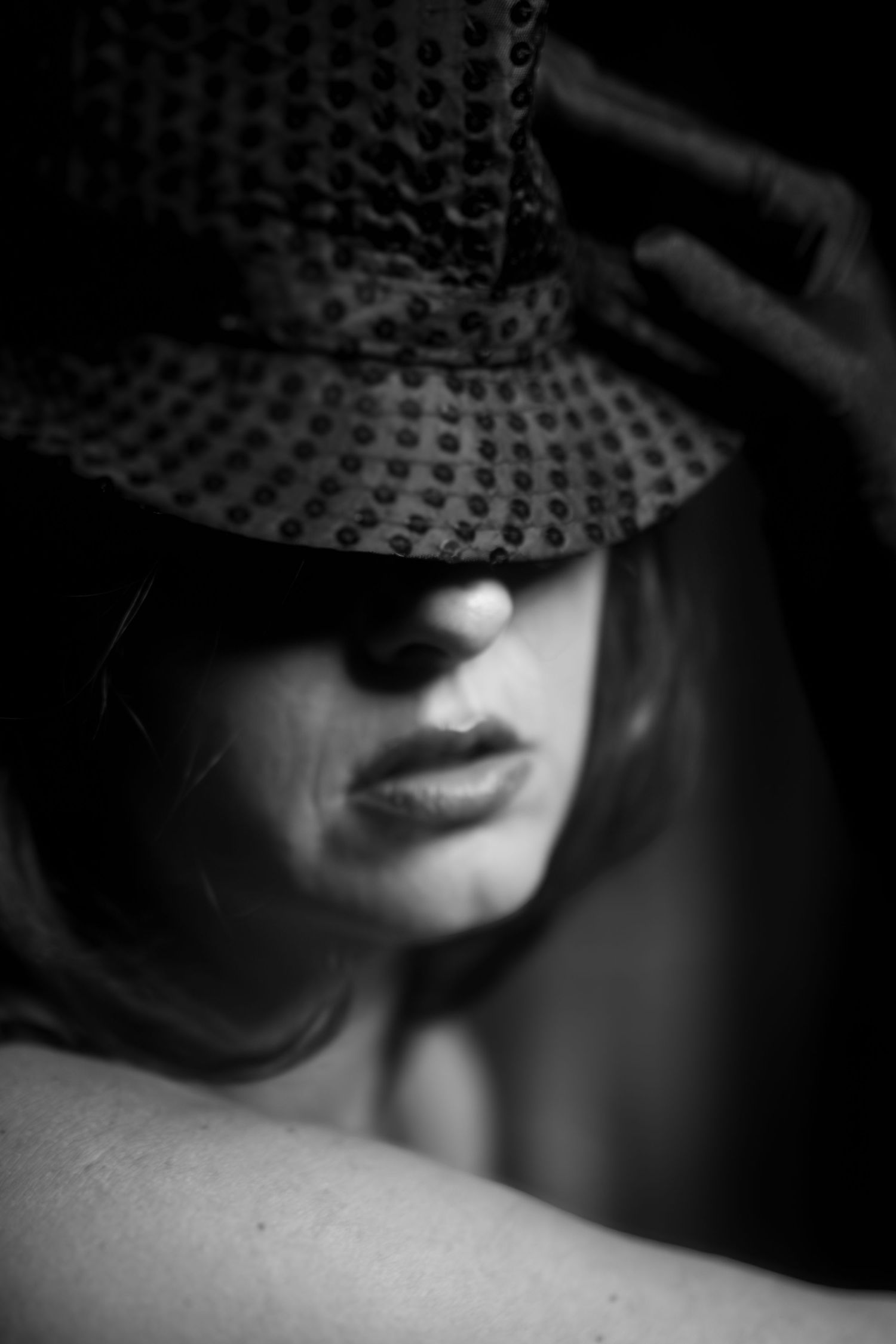 Shadowed close-up boudoir portrait, capturing emotional depth and soft power in a Fort Worth studio setting.