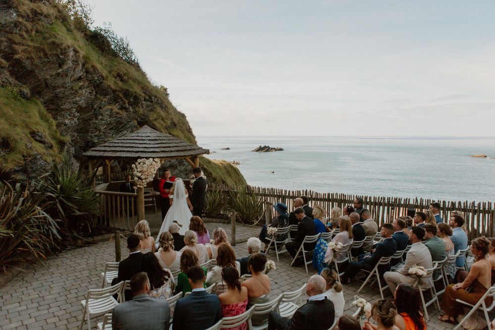 Outdoor beach ceremony at Tunnels Beaches wedding venue in Devon