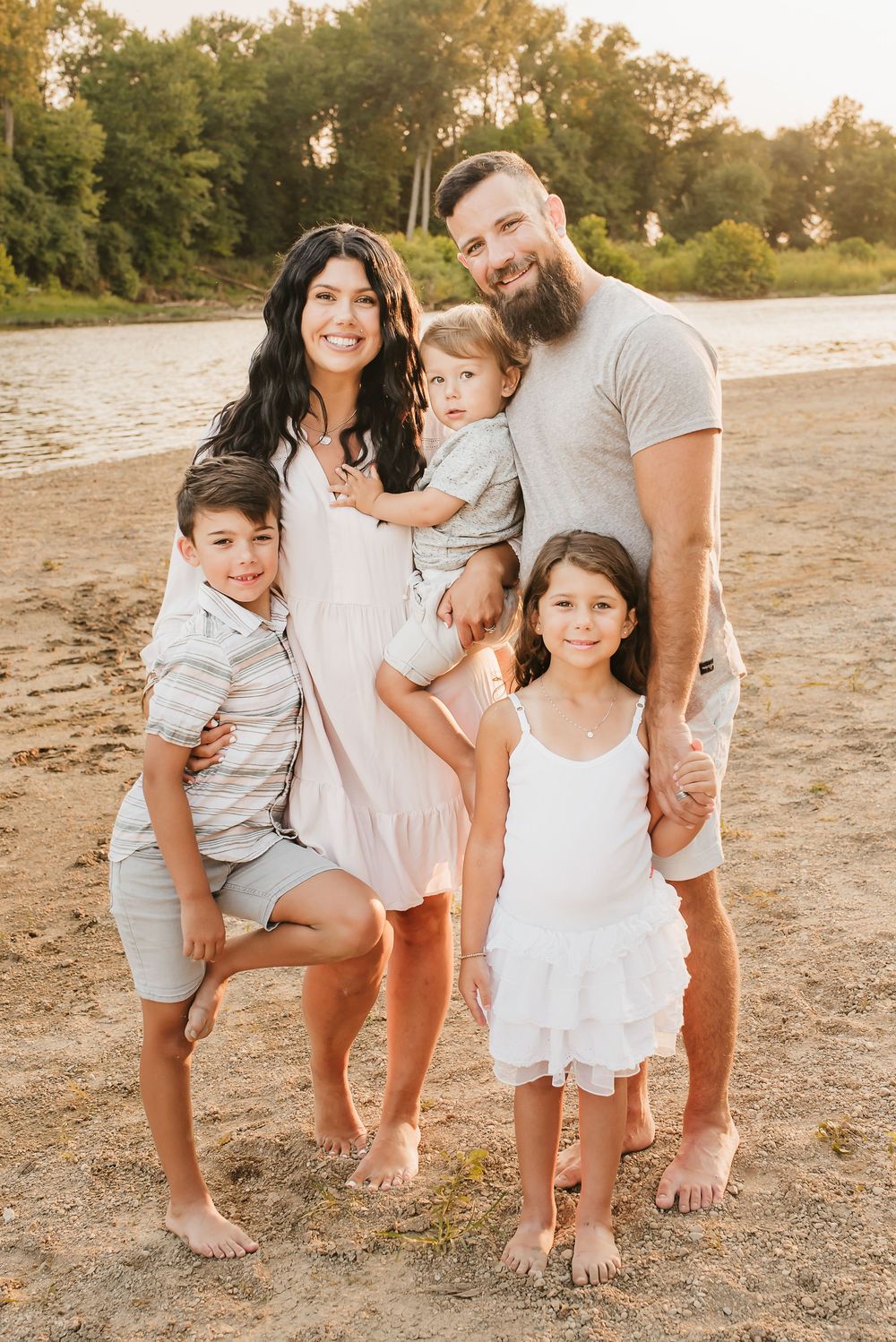 beautiful family squeezes together on beach in cincinnati, ohio