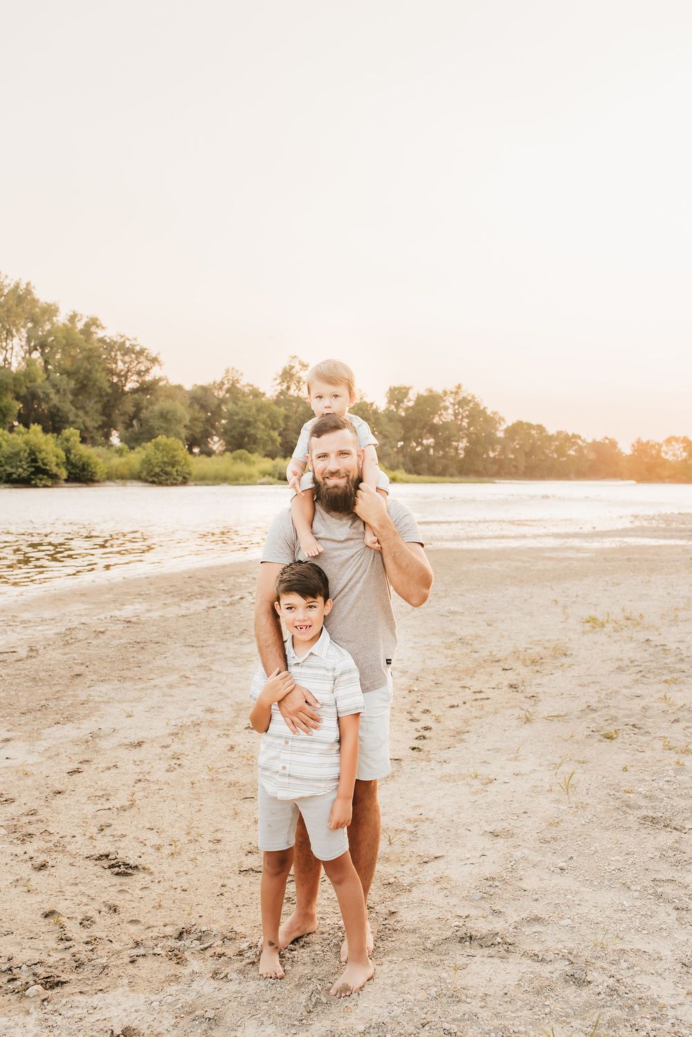 dad and his two sons hangout near the water in cincinnati, ohio