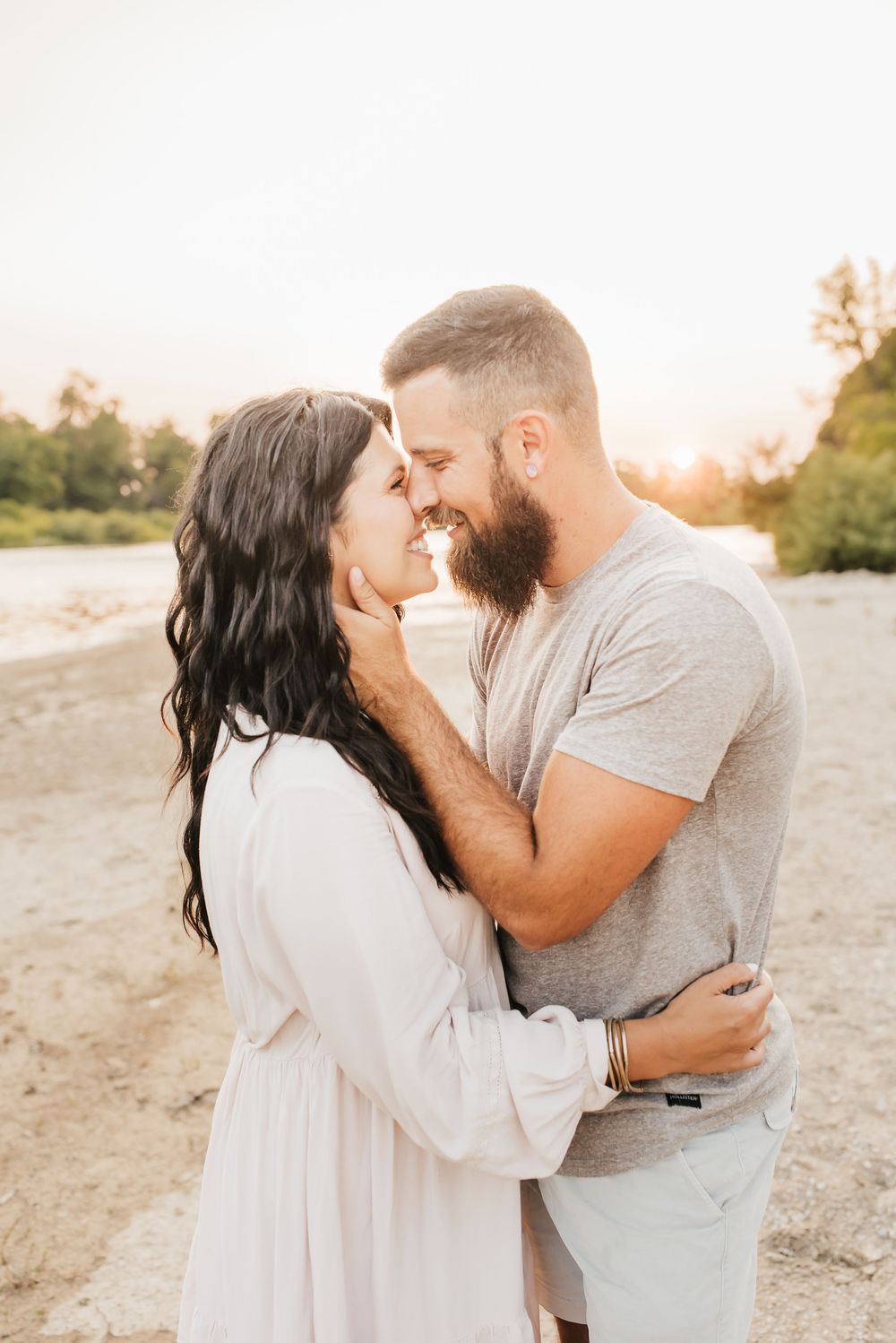husband and wife share a sweet kiss as their children play around them