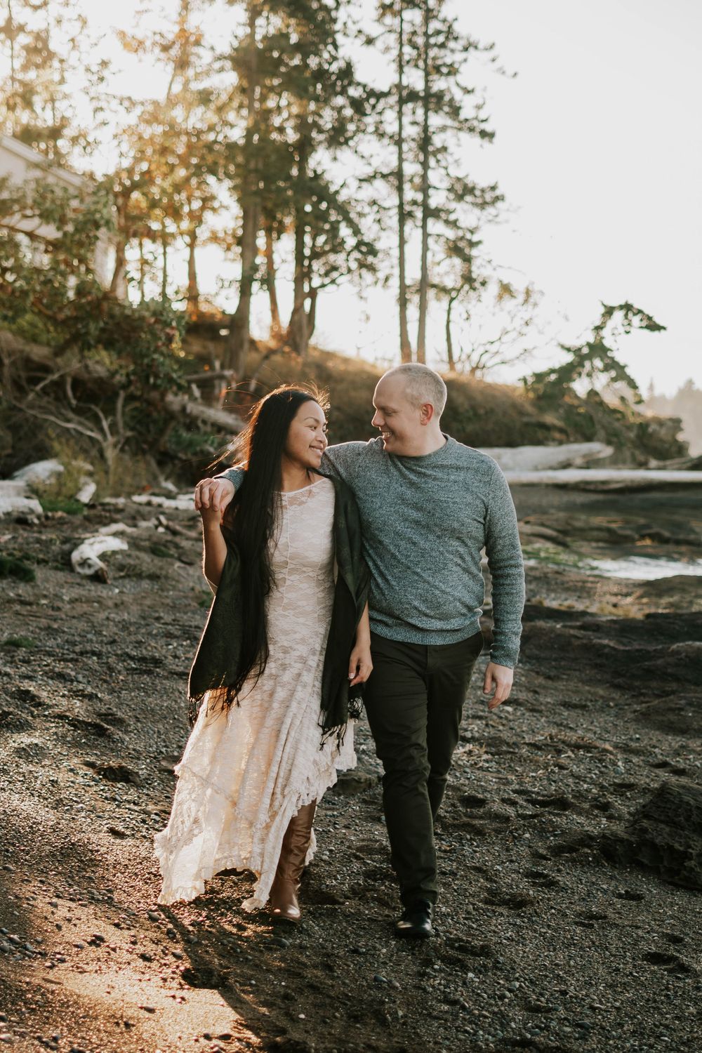 Beautiful image taken at Madrona Point Parksville Vancouver Island of couple walking along beach shore and smiling at each other photos