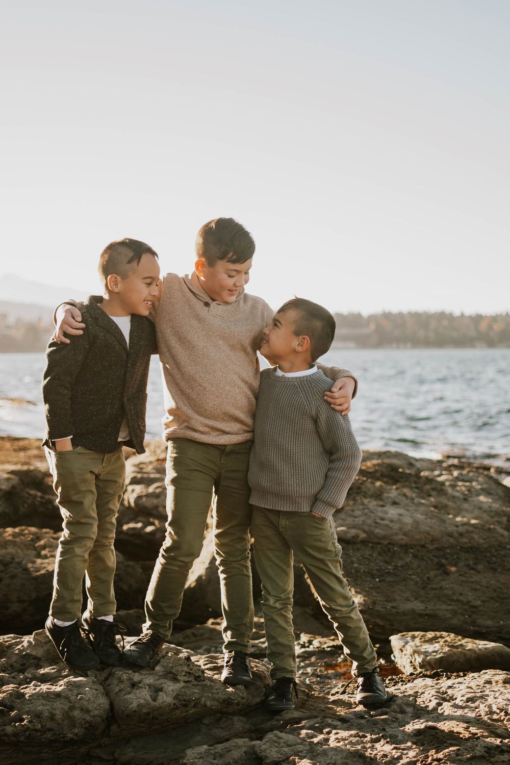 Parksville photographer portrait of the kids during family photoshoot at Madrona Point Beach on rocky shore on Vancouver Island