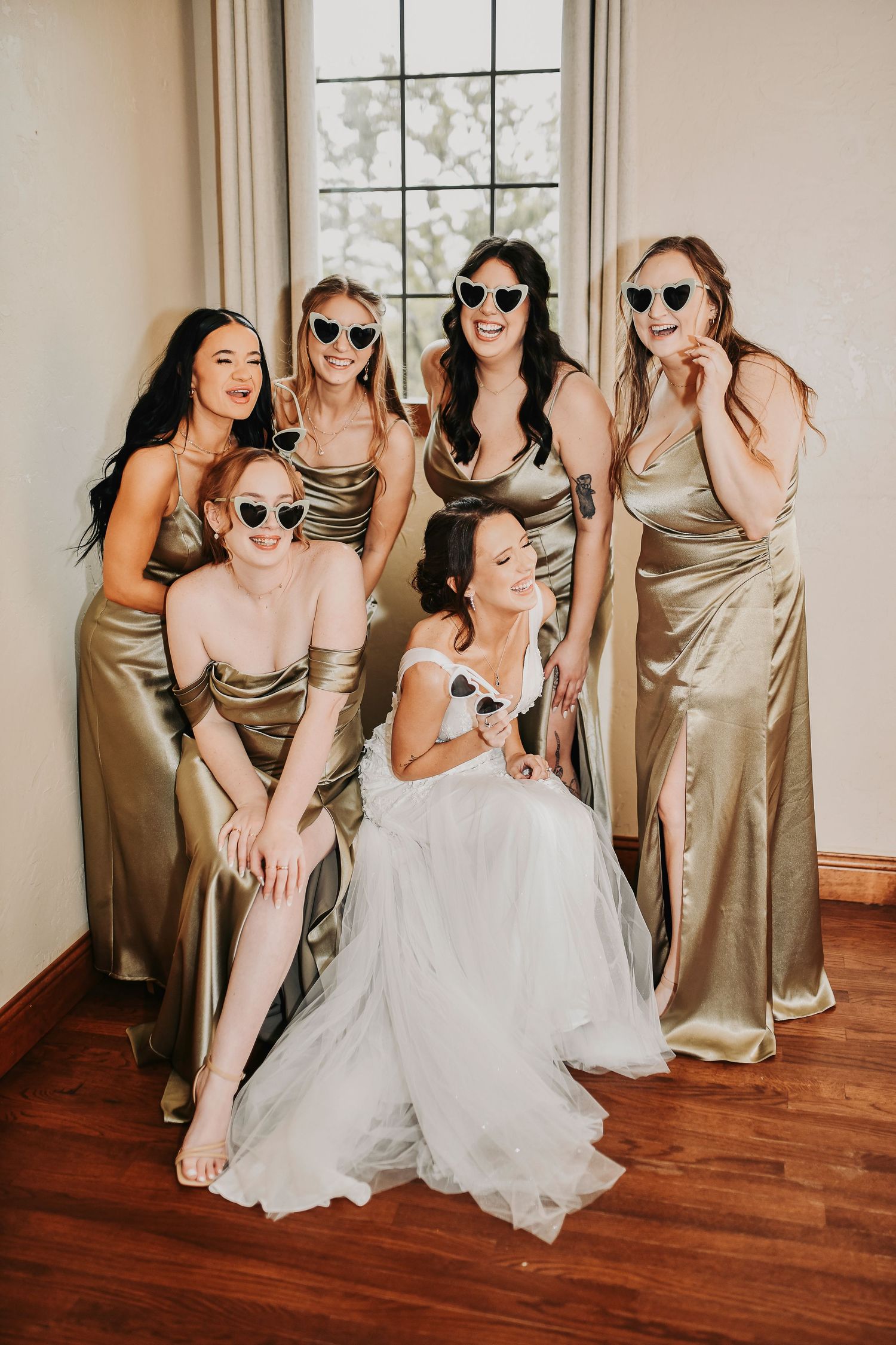 Bridal party wearing matching mint green sunglasses, laughing and having fun together before the wedding, creating joyful moments and memori
