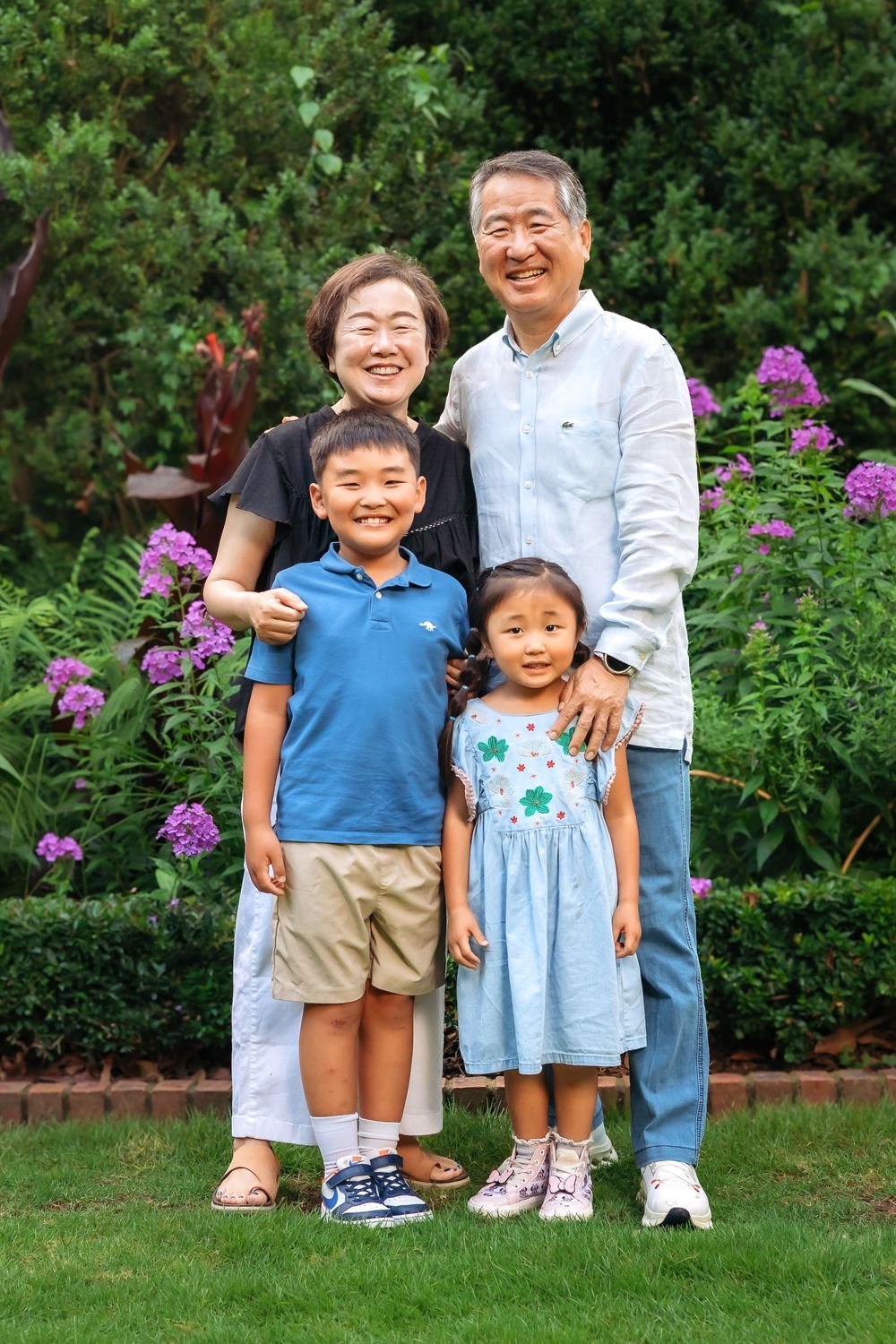 Grandparents smiling with grandchildren during family session at UGA Founders Garden in Athens GA