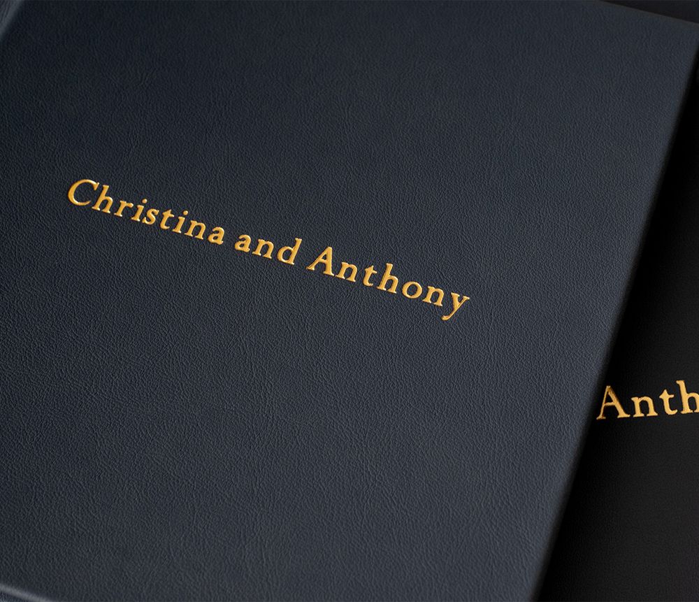 Black hardcover books with gold lettering are arranged in a row, displaying elegant typography on their spines.