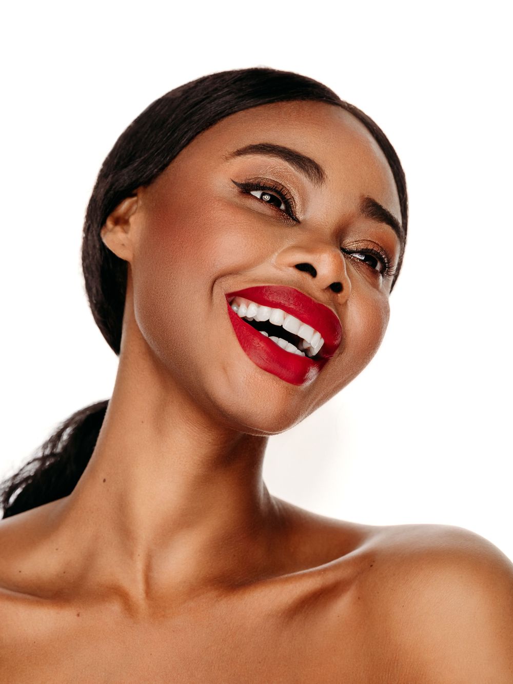 Beauty portrait featuring bright red lipstick and radiant smile.