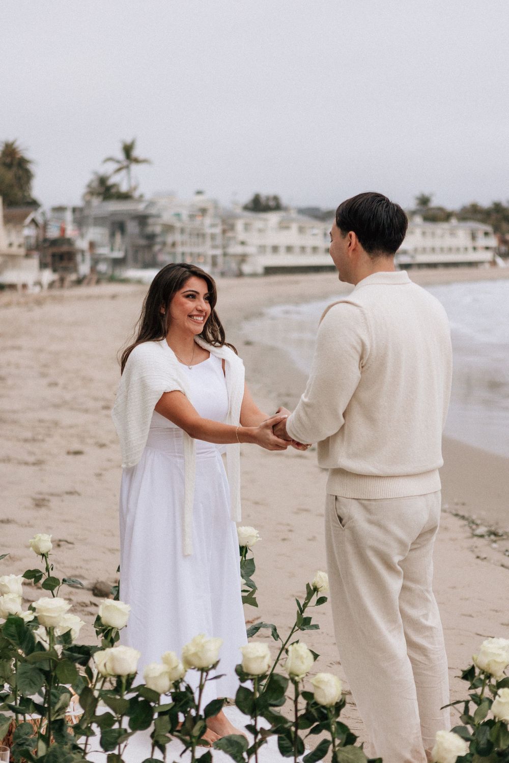 Stephanie reacting with surprise and joy during beach proposal.