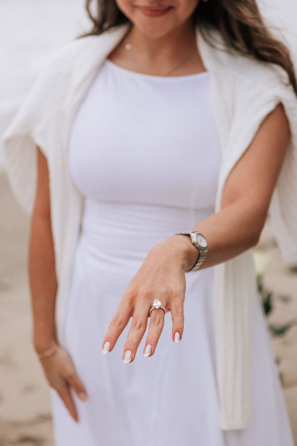 Close-up of engagement ring in proposal scene on Miramar Beach.