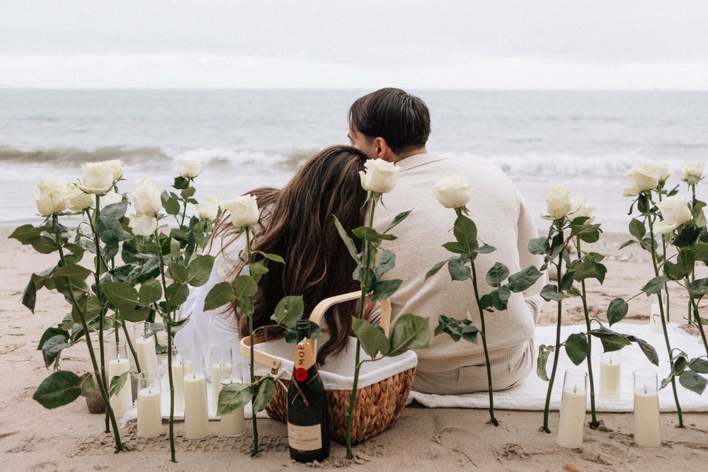 Couple surrounded by roses during romantic proposal in Santa Barbara.