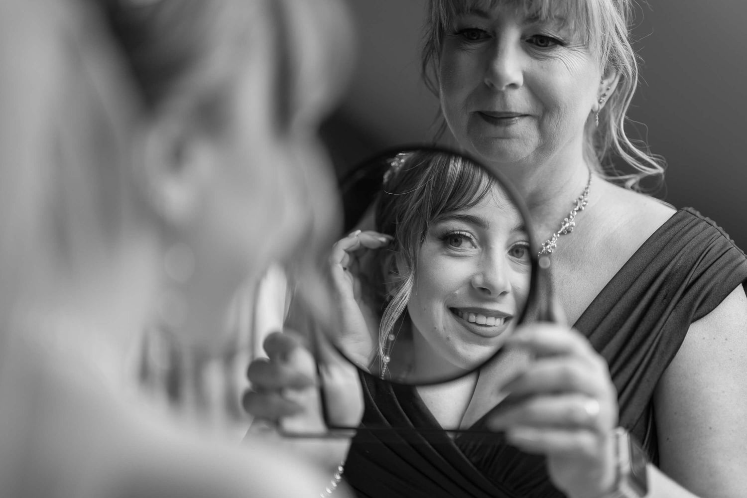 A candid black and white moment captured during what appears to be a formal event or celebration.