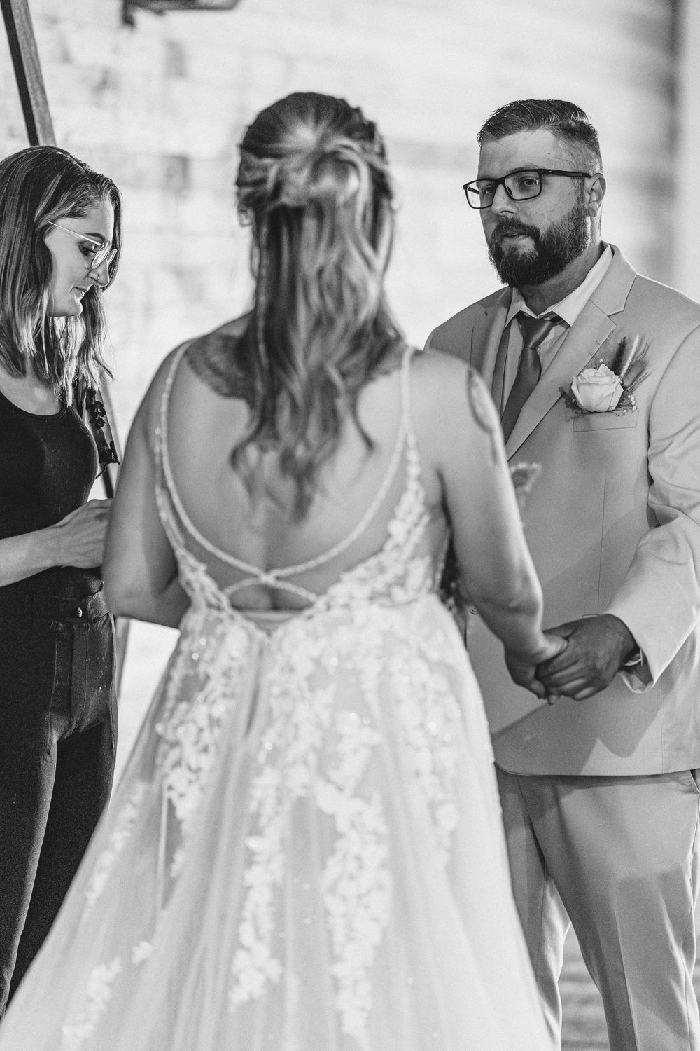 Black and white sequence of intimate dance moments at a wedding reception showing tender embraces and spins.