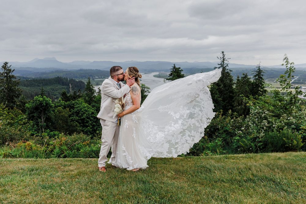 Scenic mountain landscape wedding portraits showing couple in formal attire against dramatic natural backdrop.