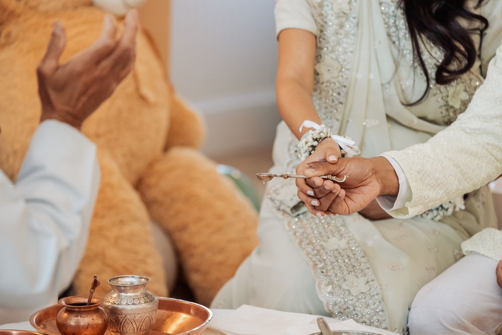 Close-up of hands holding ceremonial items during a traditional ritual.