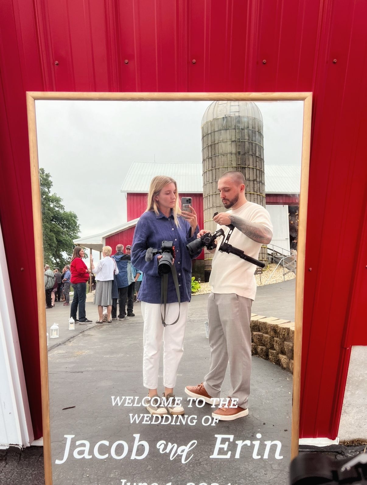 Welcome sign for a wedding featuring couple with rustic red barn background.