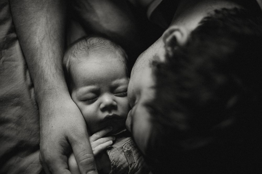 Black and white portrait capturing an intimate family moment.