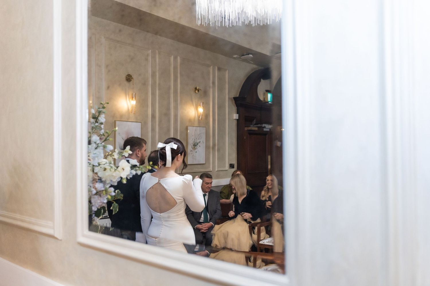 Reflection of the bride and groom during the ceremony in the Brydon room