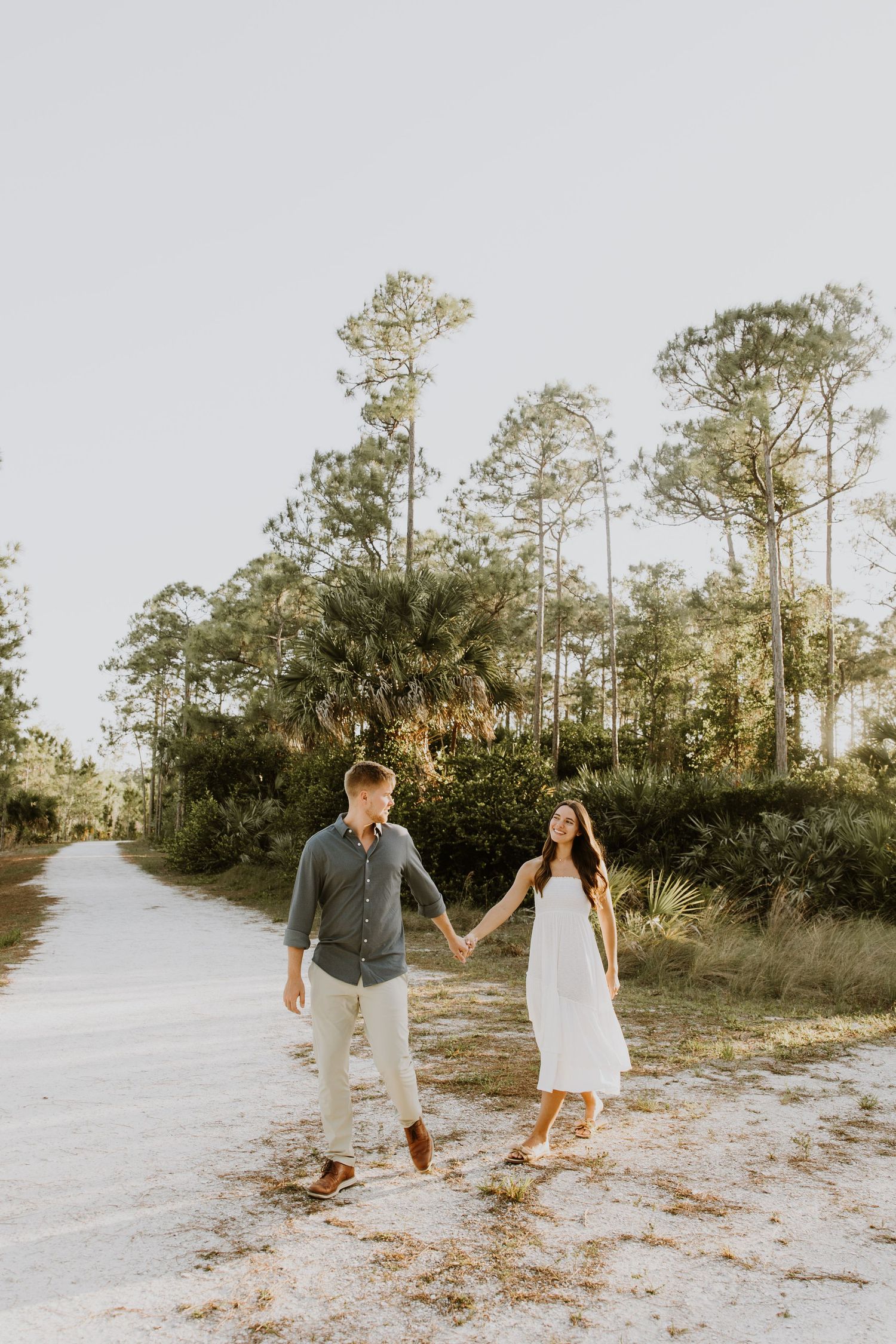 Golden hour Engagement photos captured by Lindsay McDow Photography in the greenery of a nature trail in West Palm Beach, Florida