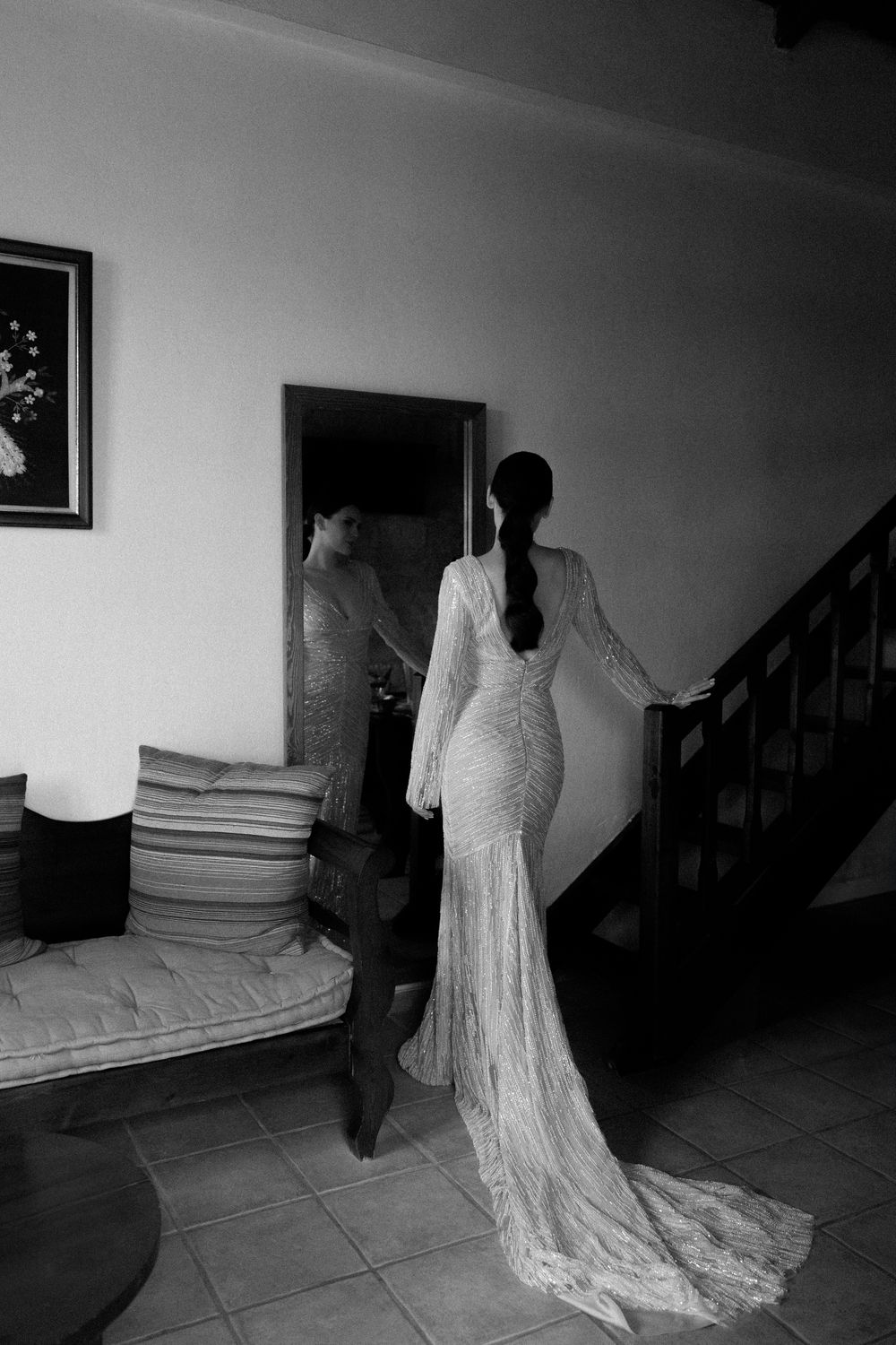 Elegant lace wedding dress with long train photographed from behind in dramatic lighting. Wedding Agreco Farms, Crete