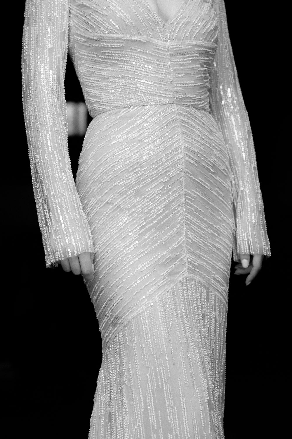 A detailed close-up of a form-fitting beaded wedding gown showing intricate diagonal patterns. Wedding Agreco Farms, Crete