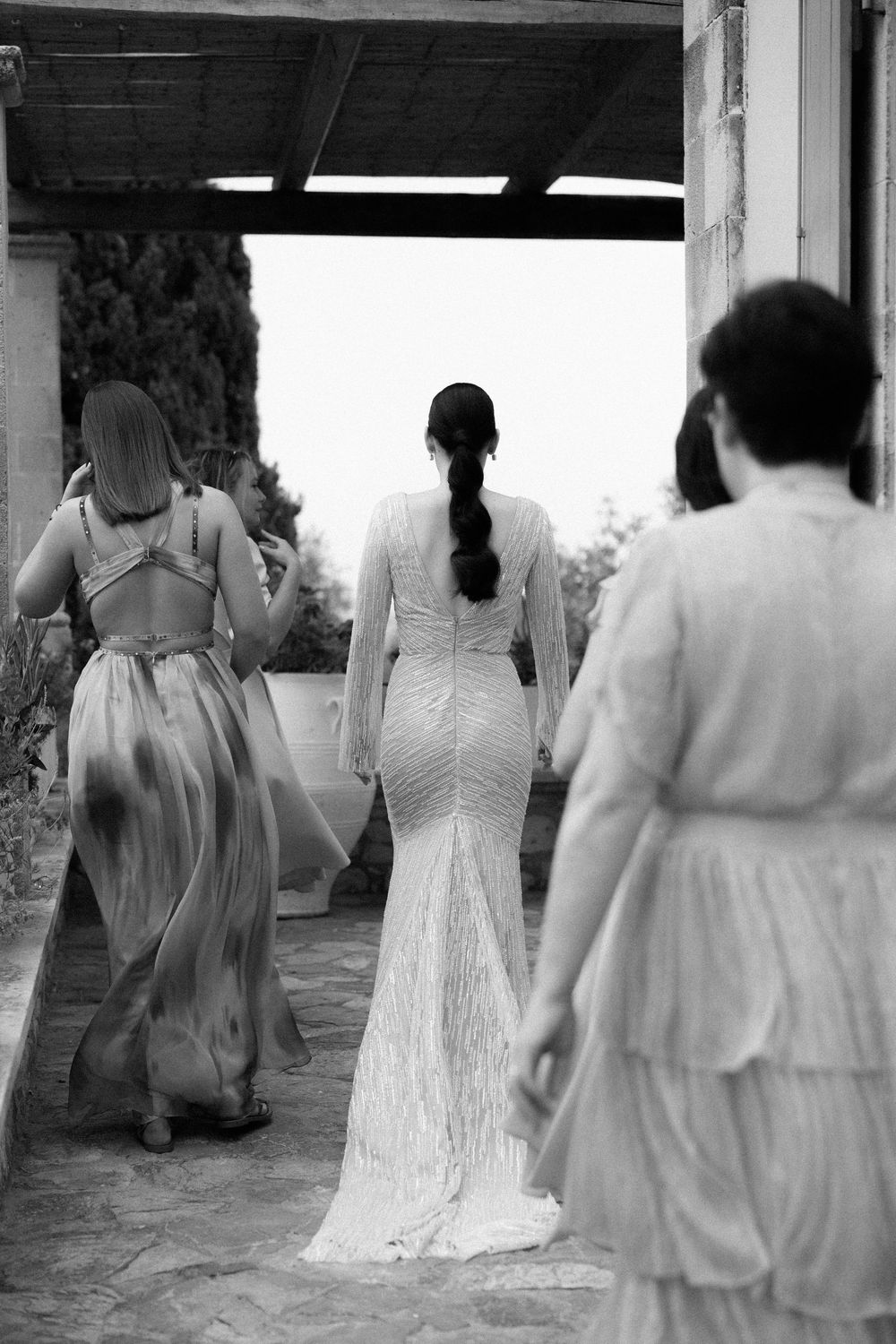 A candid black and white moment showing a bride with her bridesmaids during wedding preparations. Wedding Agreco Farms, Crete