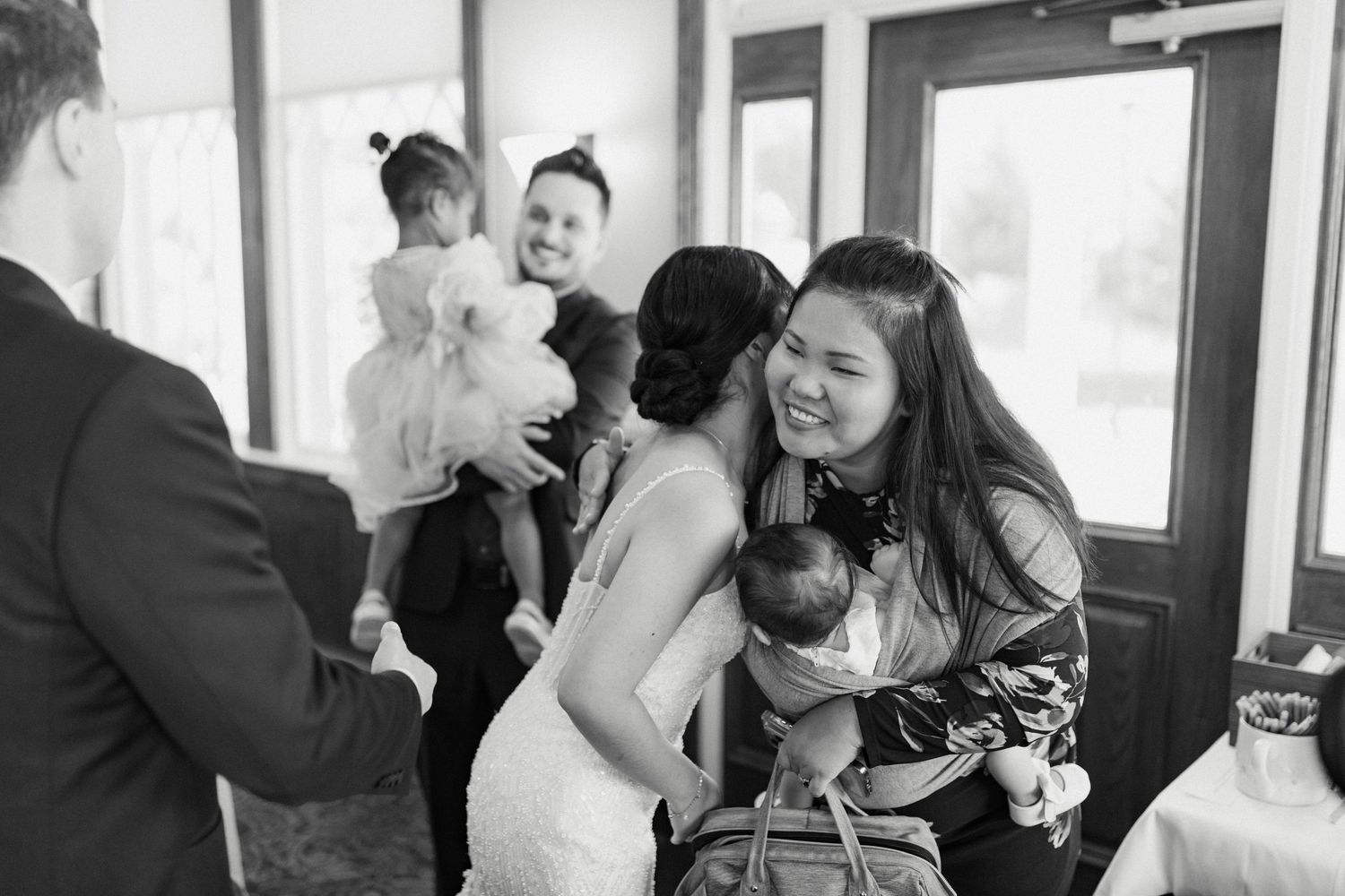 Wedding guests gather indoors during a reception celebration.
