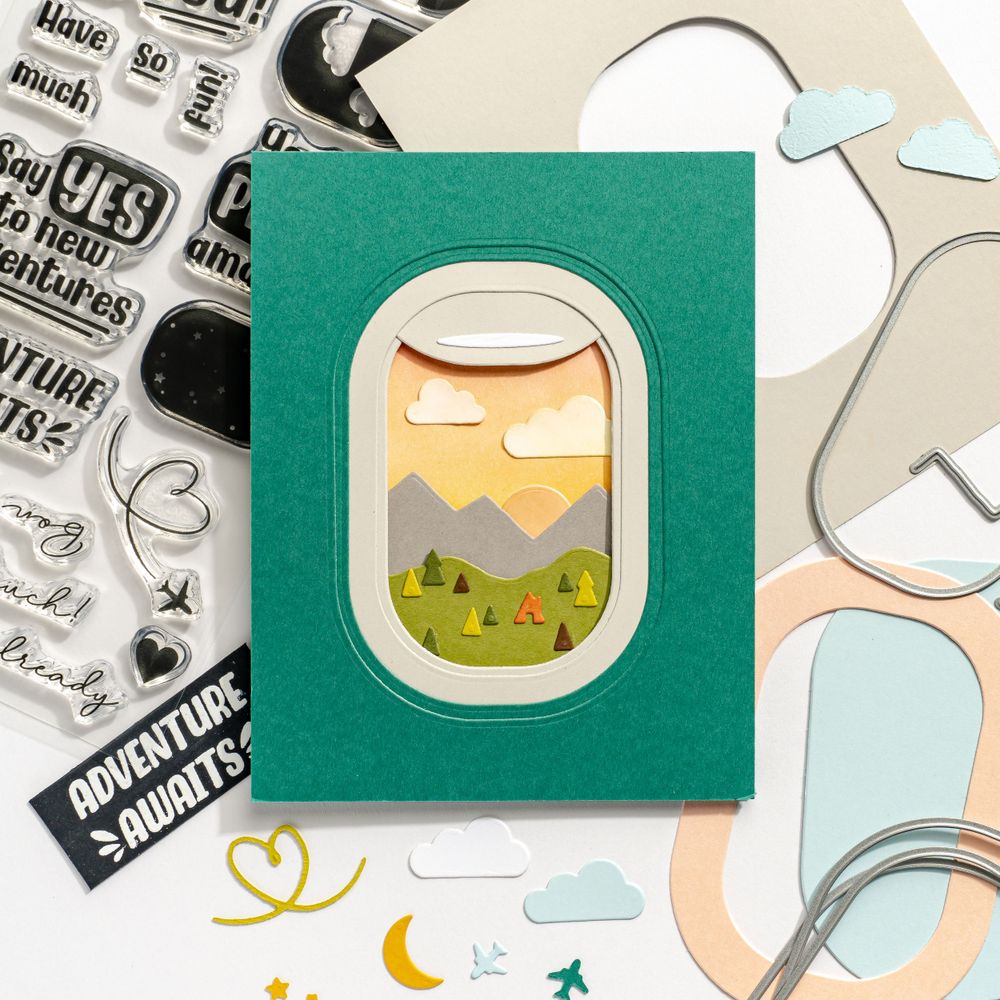 Airplane window card craft design with stamps and decorative elements.