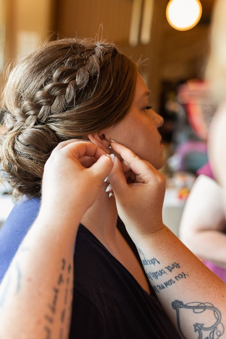 Detail photo of bride putting in earrings Duluth Minnesota Wedding