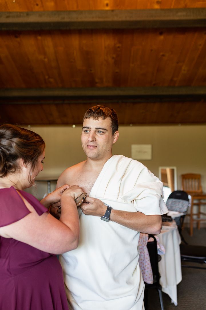 Best Man in Toga - bridesmaid pinning into place