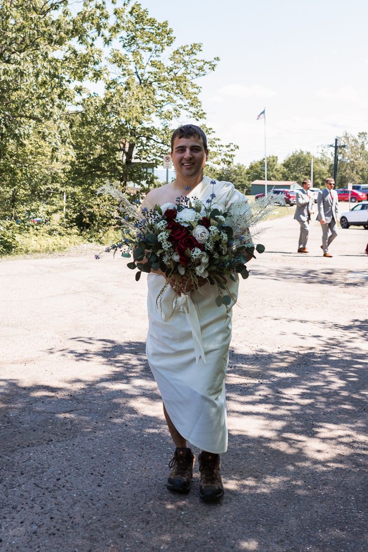 Groomsman surprising groom with first look photo in a dress