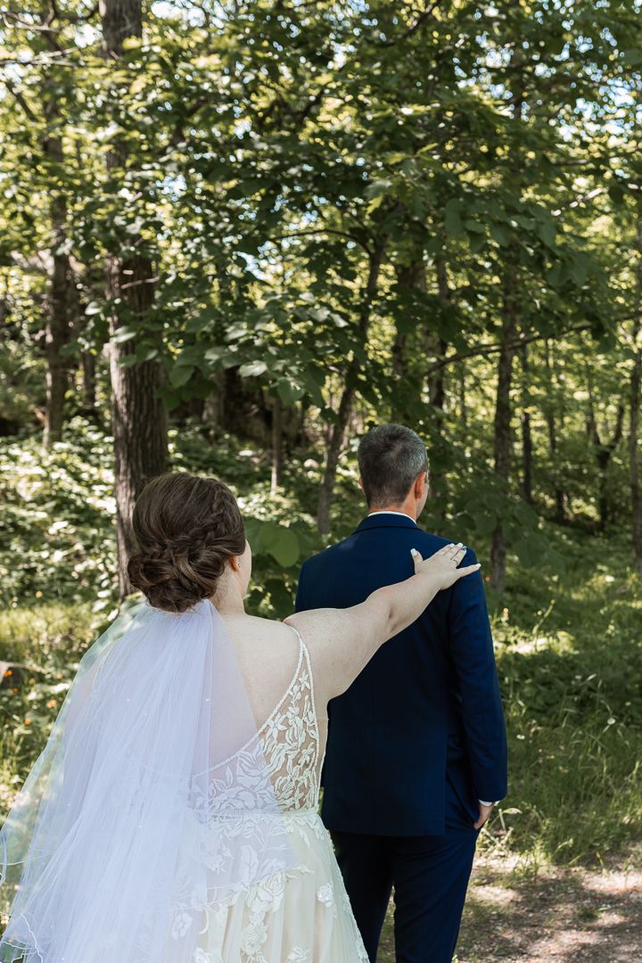First look of Bride and Groom at Spirit Mountain in Duluth - Bride taps shoulder