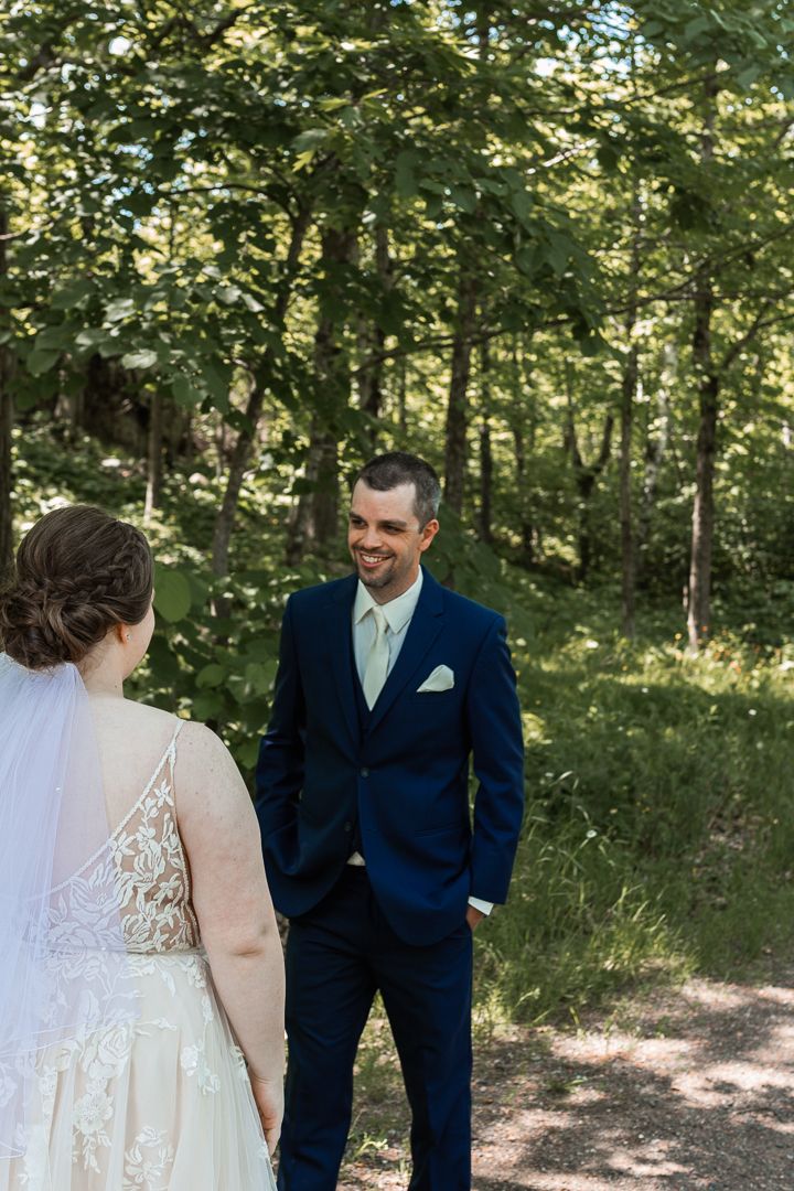 First look of Bride and Groom at Spirit Mountain in Duluth - Bride taps shoulder
