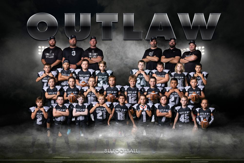 Football squad group photo featuring players and coaching staff arranged in rows with smoky atmosphere.