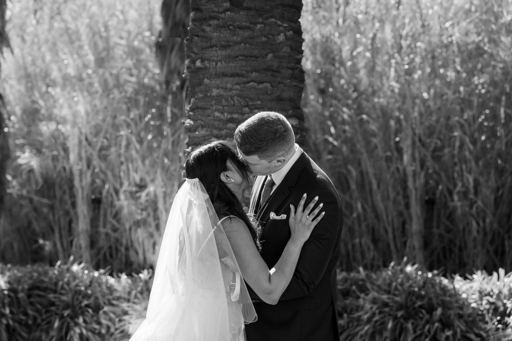 Black and white portrait of wedding couple embracing in intimate moment.