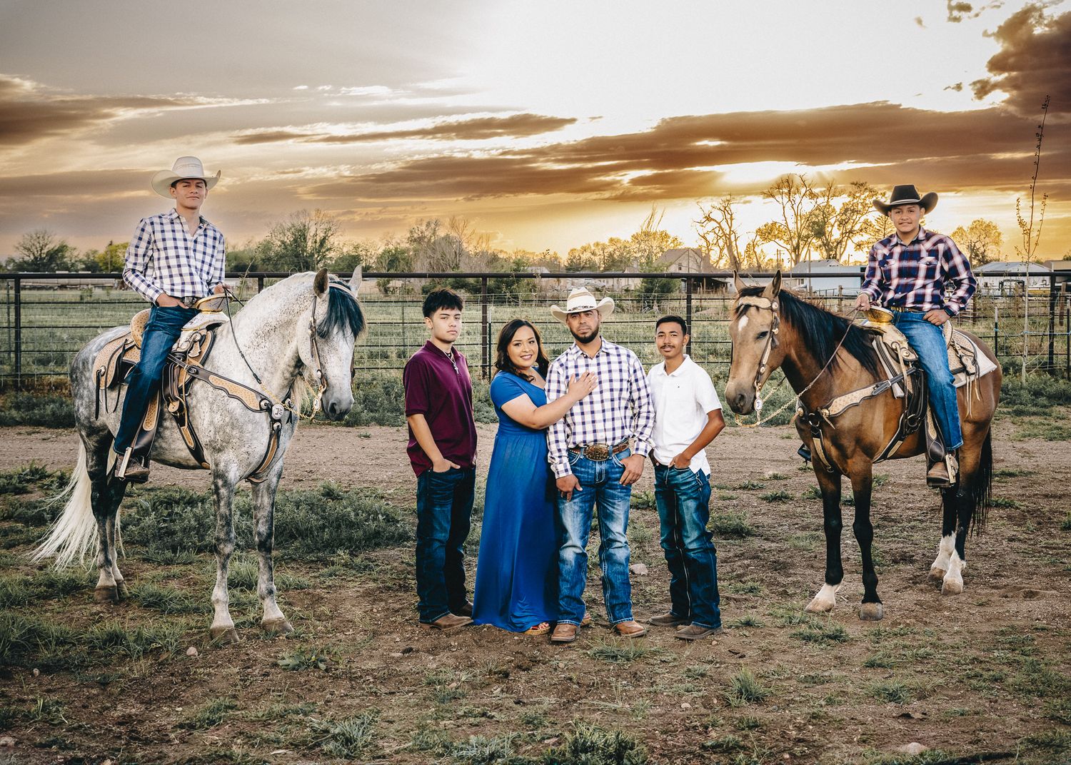 sunset family session at ranch with horses in colorado. family of 6 posing in the mountains.liz rivas illuminating images.