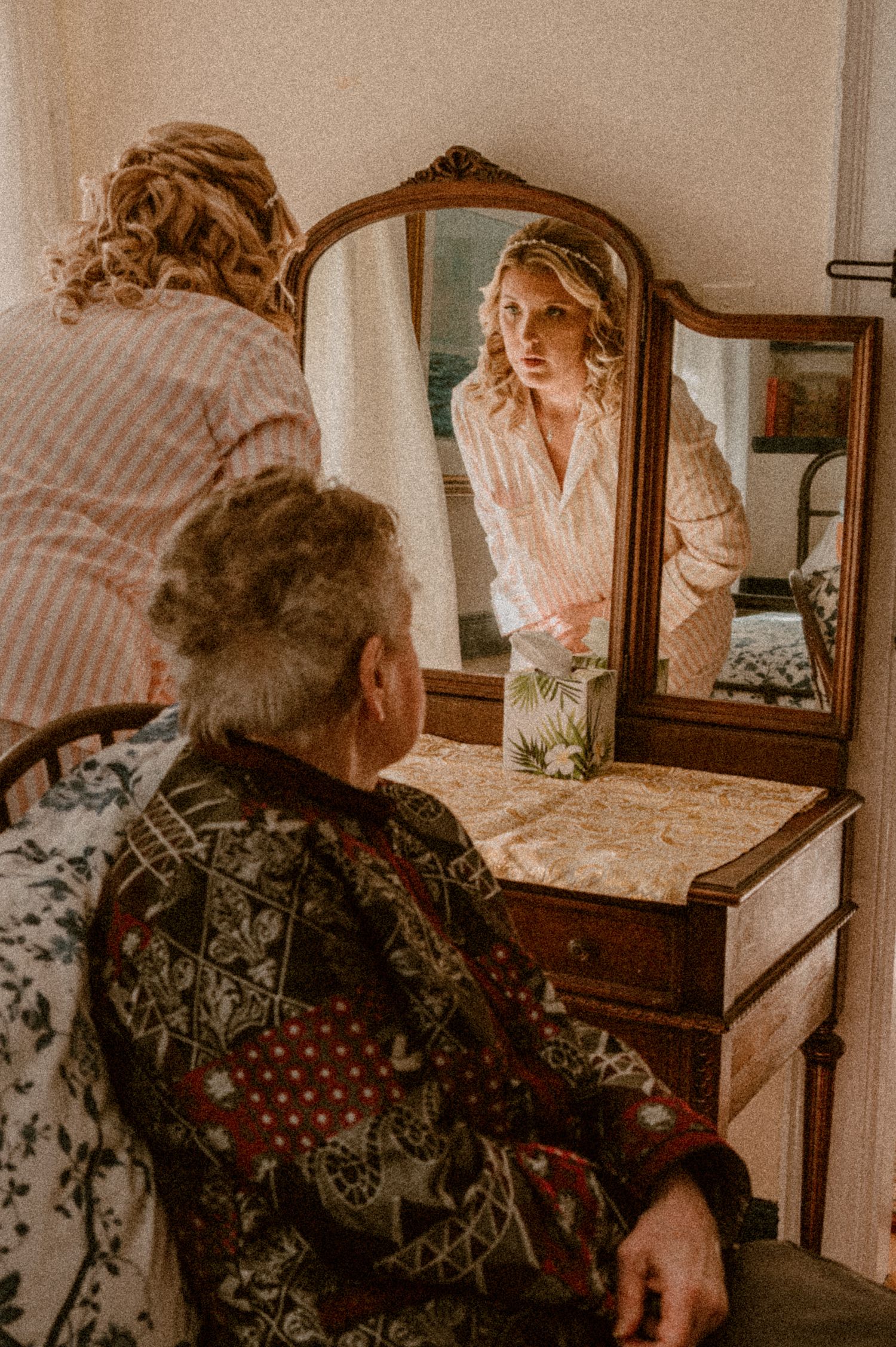 Vintage-style, warm, nostalgic lighting, refection photograph by Samantha Campbell Imagery showing bride getting ready for wedding.