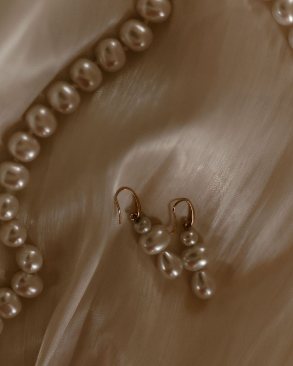 Close-up macro photography of water droplets forming an abstract pattern in sepia tones.