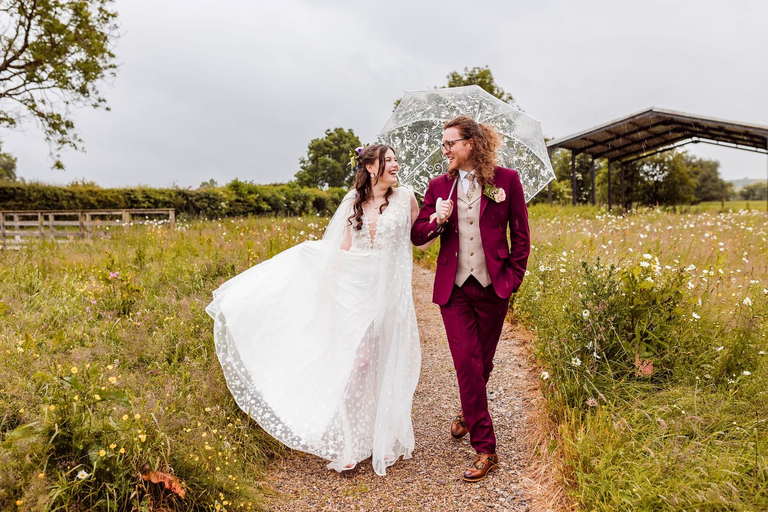 Wedding guests gathered outdoors throw flower petals in celebration during the couple's wedding ceremony exit.