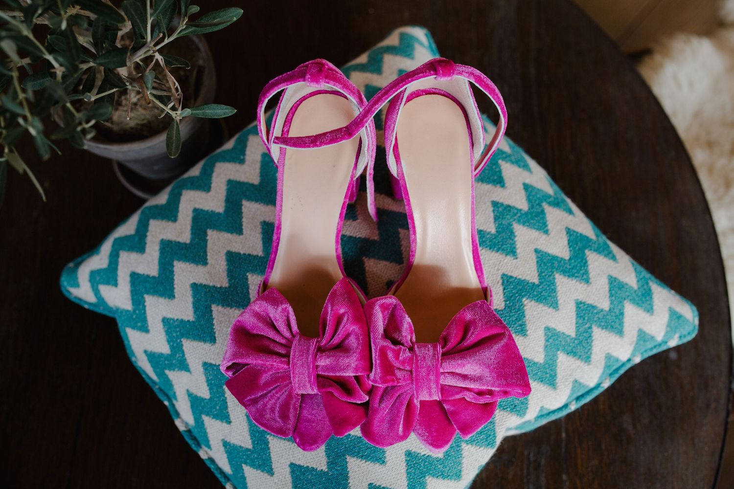 Blue chevron gift box with pink bow and shoes arranged in sequence showing wrapping and presentation steps.