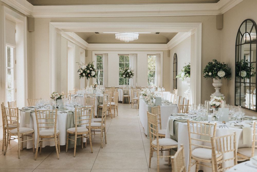 Elegant white wedding reception venue with natural light features round tables at Saltmarshe Hall - taken by Grimsby photographer.